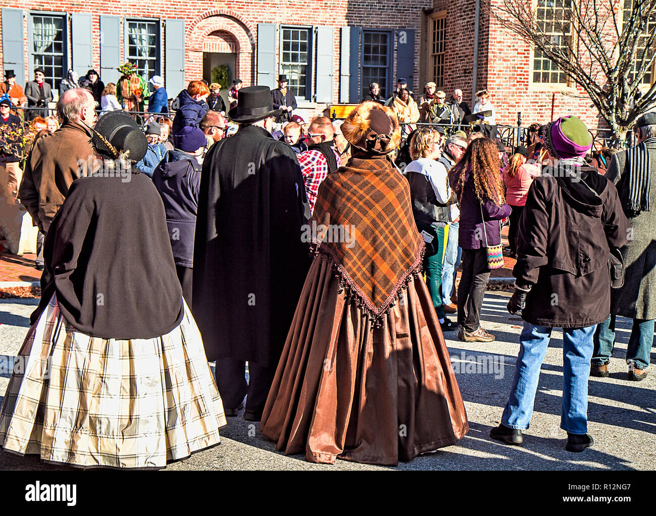 Christmas celebration in Old New Castle with actors in costumes from  a play performed on grounds mingling among visiting guests. Stock Photo