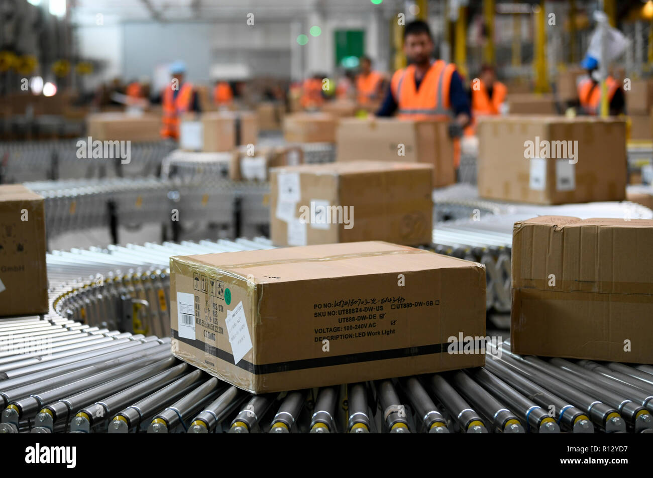 Dortmund, Germany. 08th Nov, 2018. An employee sorts parcels in the  logistics center of the mail order company Amazon at goods receipt. In  Europe's first redistribution centre automated with conveyor technology,  goods