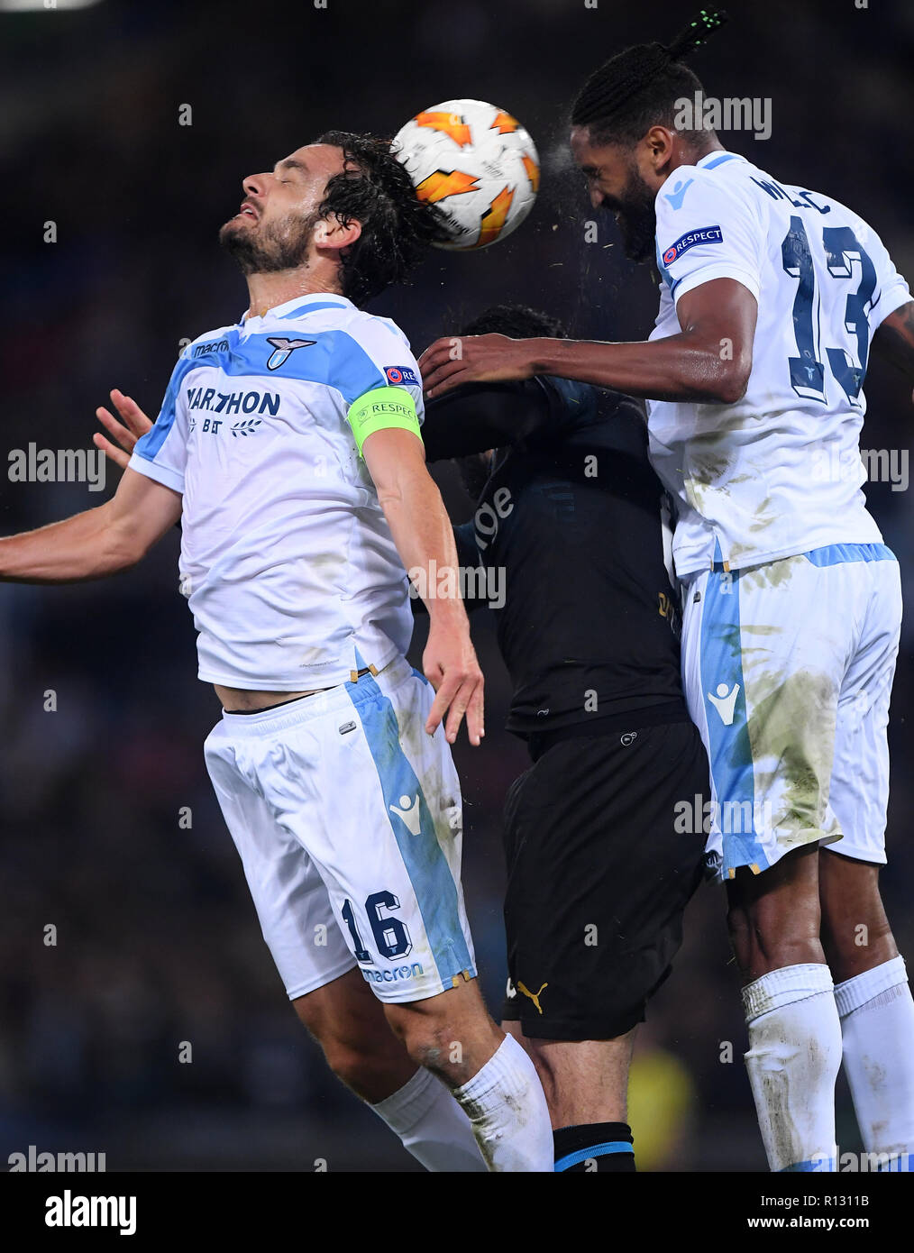 Rome, Italy. 8th Nov, 2018. Lazio's Marco Parolo (L) and Wallace (R) vie with Marseille's Adil Rami during the UEFA Europa League Group H match between Lazio and Marseille in Rome, Italy, Nov. 8, 2018. Lazio won 2-1. Credit: Alberto Lingria/Xinhua/Alamy Live News Stock Photo