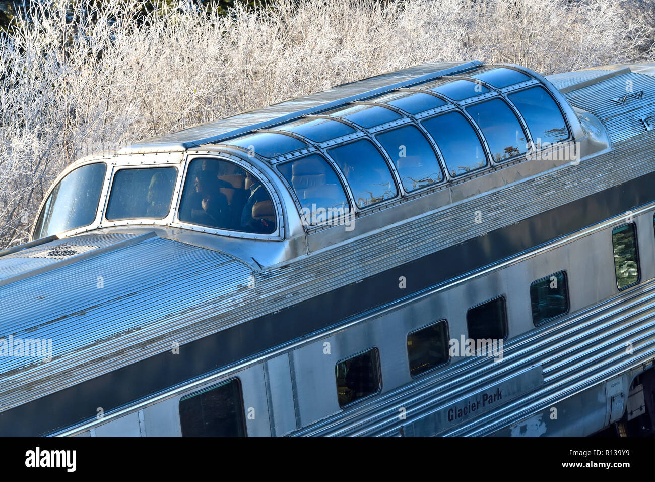 A horizontal image of an observation car on a Via Rail train with passengers looking at the scenic view in rural Alberta Canada. Stock Photo
