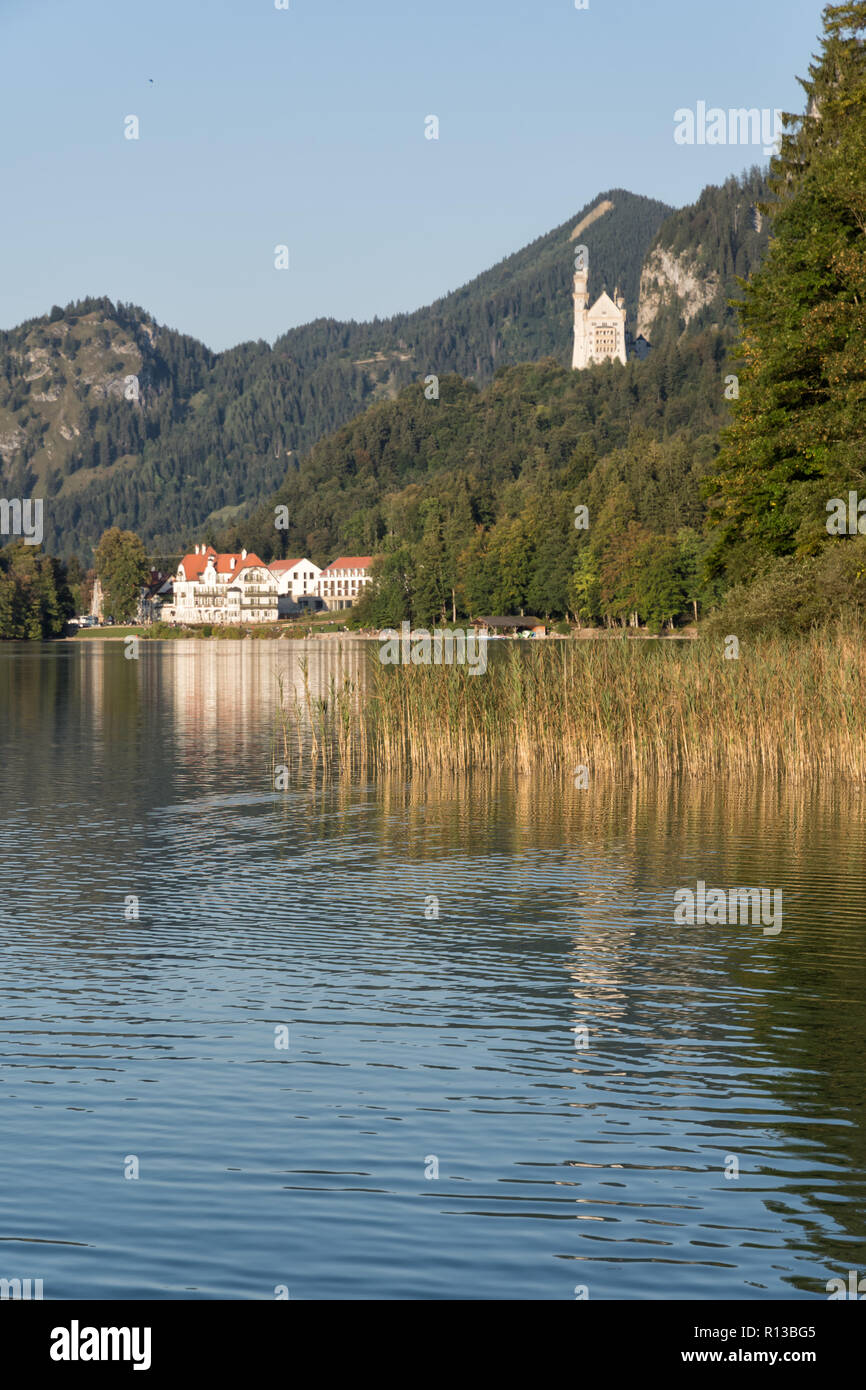 Lake 'Alpsee', Füssen, with Hohenschwangau, Neuschwanstein and Restaurant Alpenrose on a warm sunny evening in late September. Schwangau, Bavaria Stock Photo