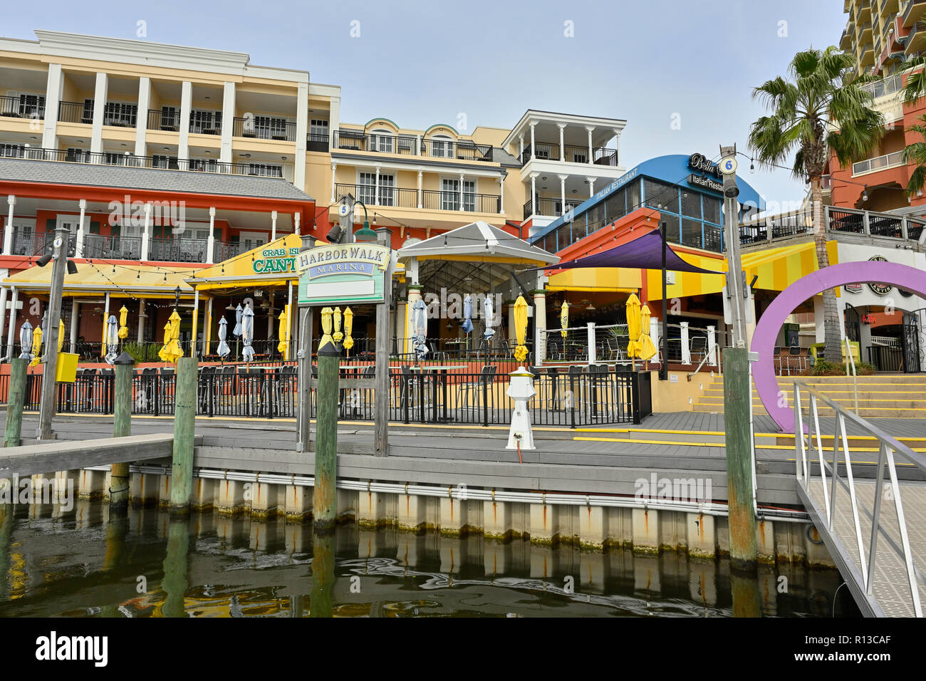 Empty boat slip at the HarborWalk Marina with the stores and shops of Harbor Walk Village in the background, in Destin Florida, USA. Stock Photo