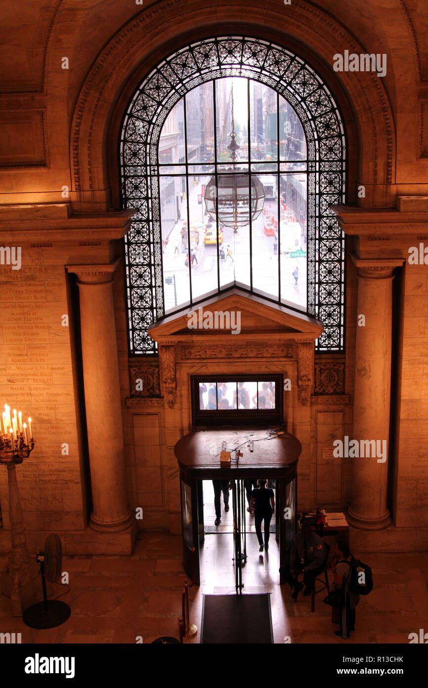 Front entrance to New York Central Library (built 1902) with view of city street through arched glass transom, New York, NY Stock Photo