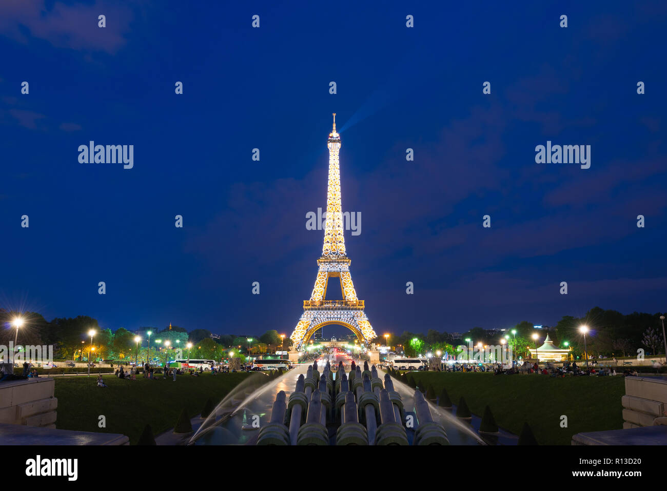 PARIS, FRANCE - May 8, 2016:  Tourist sightseeing beautiful night scene of illuminated Eiffel Tower at dusk, Paris, France. Stock Photo