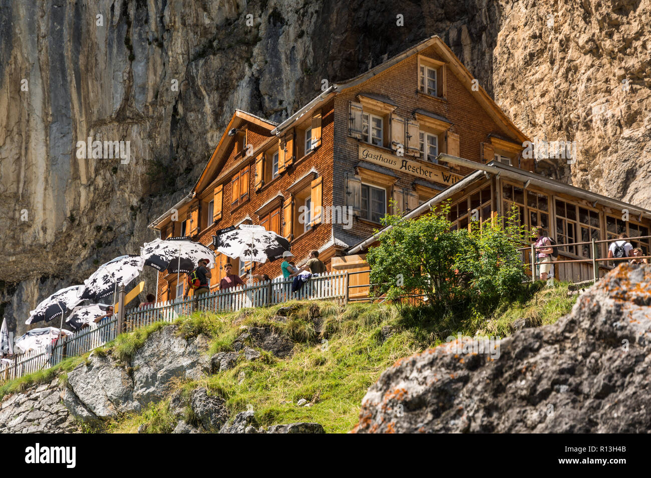 APPENZELL, SWITZERLAND - AUGUST 7, 2016: Tourists enjoying relaxing time at Aesher mountain hut in Swiss Alps near Appenzell during hot August of 2016 Stock Photo