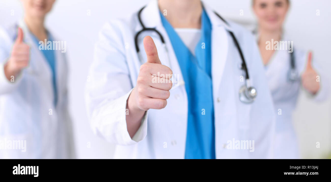 Groupe of medicine doctors show OK sign with thumb up close up. Success ...