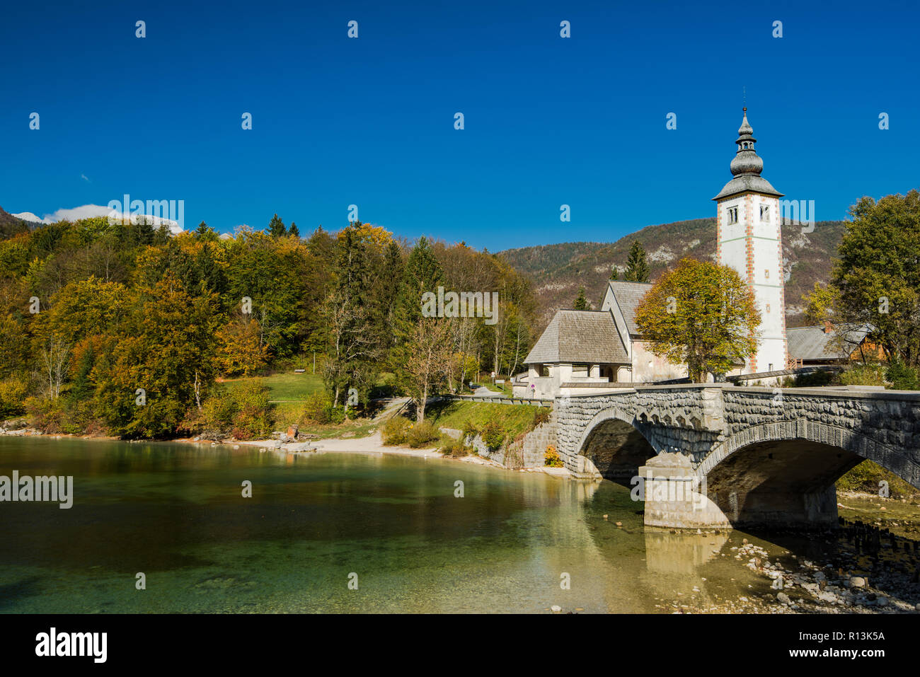 Gothic Church of St. John the Baptist and stone bridge in Ribcev Laz ...