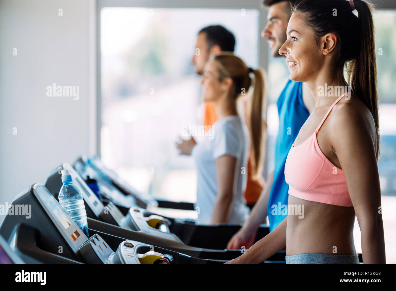 Pretty girl working out in a treadmill at the gym Stock Photo - Alamy