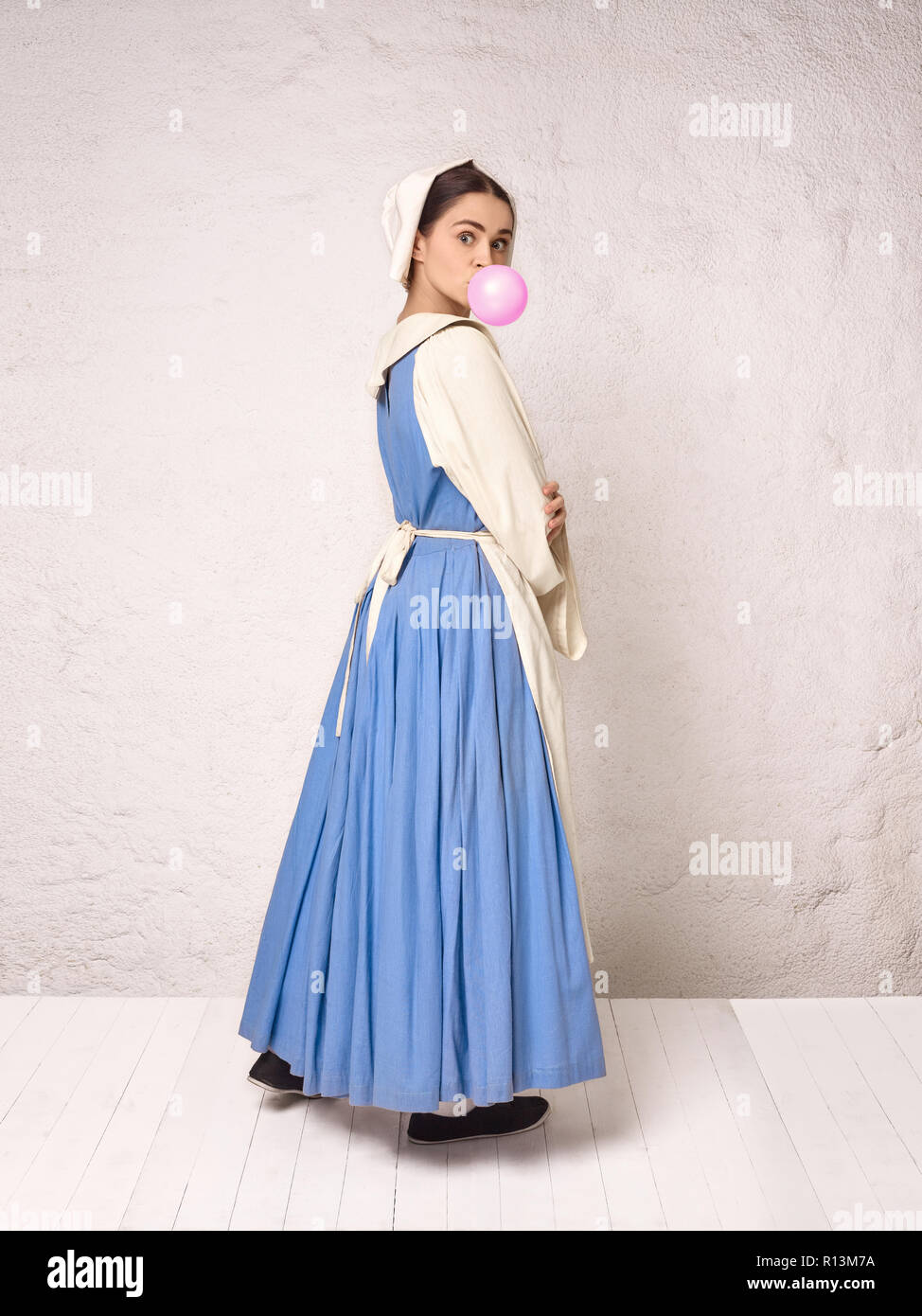 Medieval Woman in Historical Costume Wearing Corset Dress and Bonnet.  Beautiful peasant girl wearing thrush costume with bubble gum Stock Photo -  Alamy