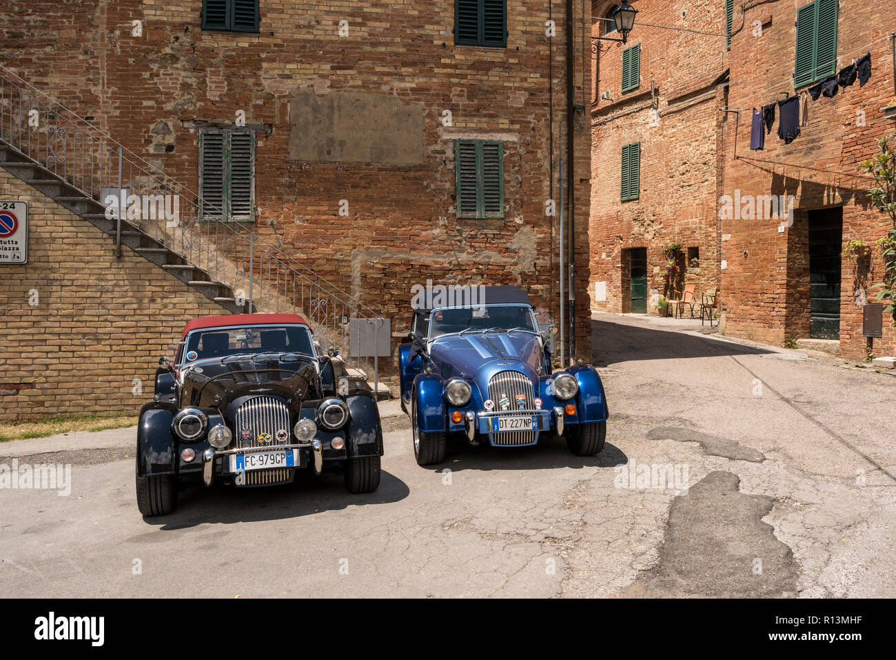 Black and blue British Morgan classic vintage cars parked in Chiusure, a small village in the Province of Siena, Tuscany, Italy Stock Photo