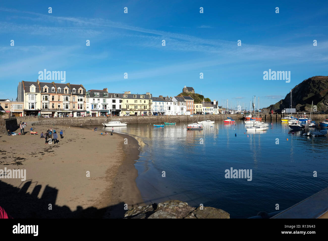 Ilfracombe harbour North Devon showing sandy beach in the bay looking toward the harbour mouth in early winter Stock Photo