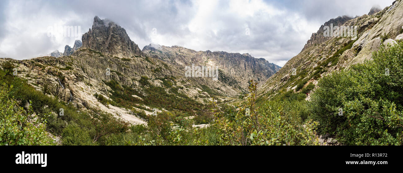 Panoramic view of the Restonica valley in front of Lombarduccio, a 2261m high mountain in Corsica. La Restonica river can be seen flowing down. Stock Photo