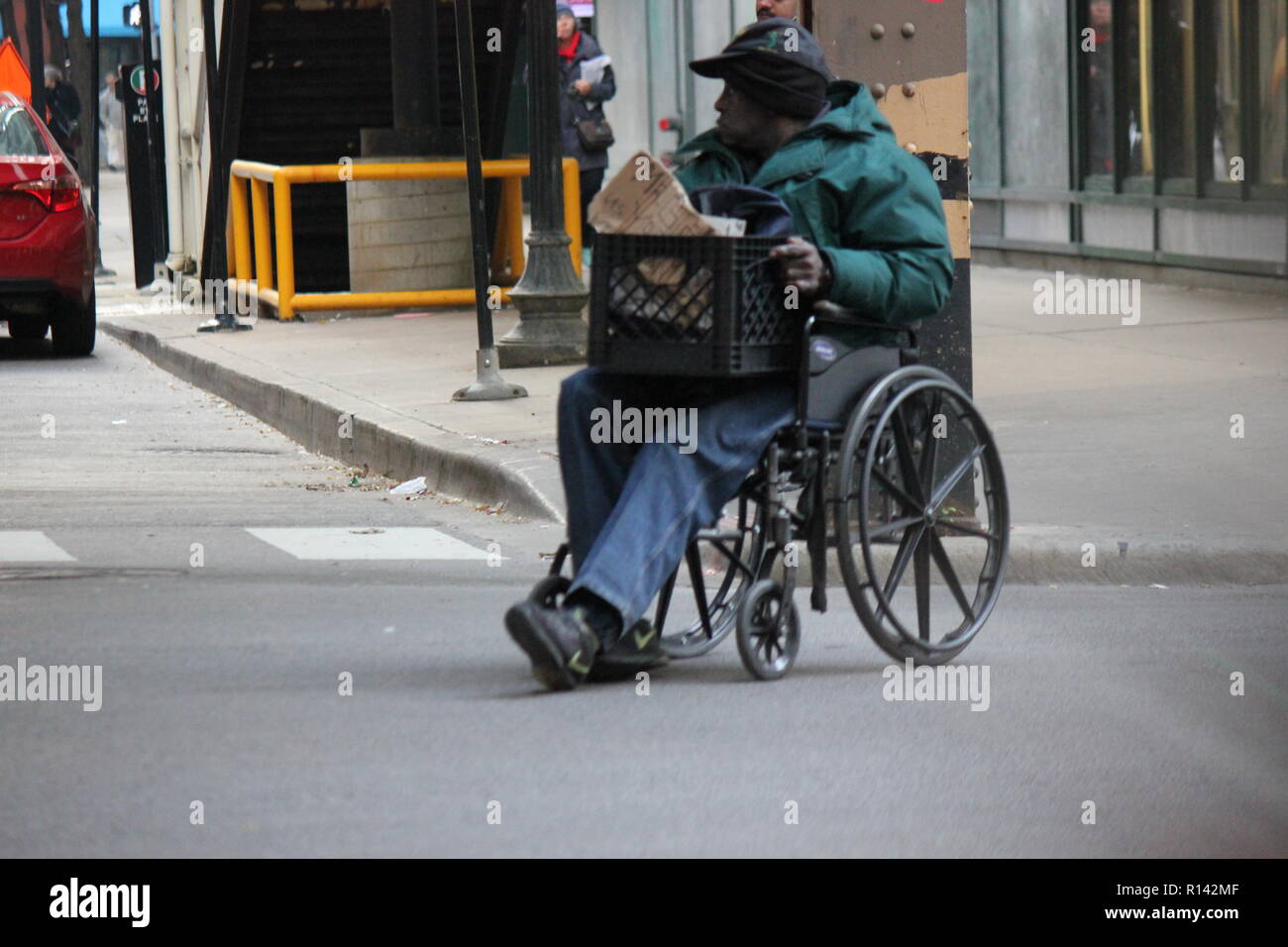Disabled man pushing himself and his wheelchair diagonally and