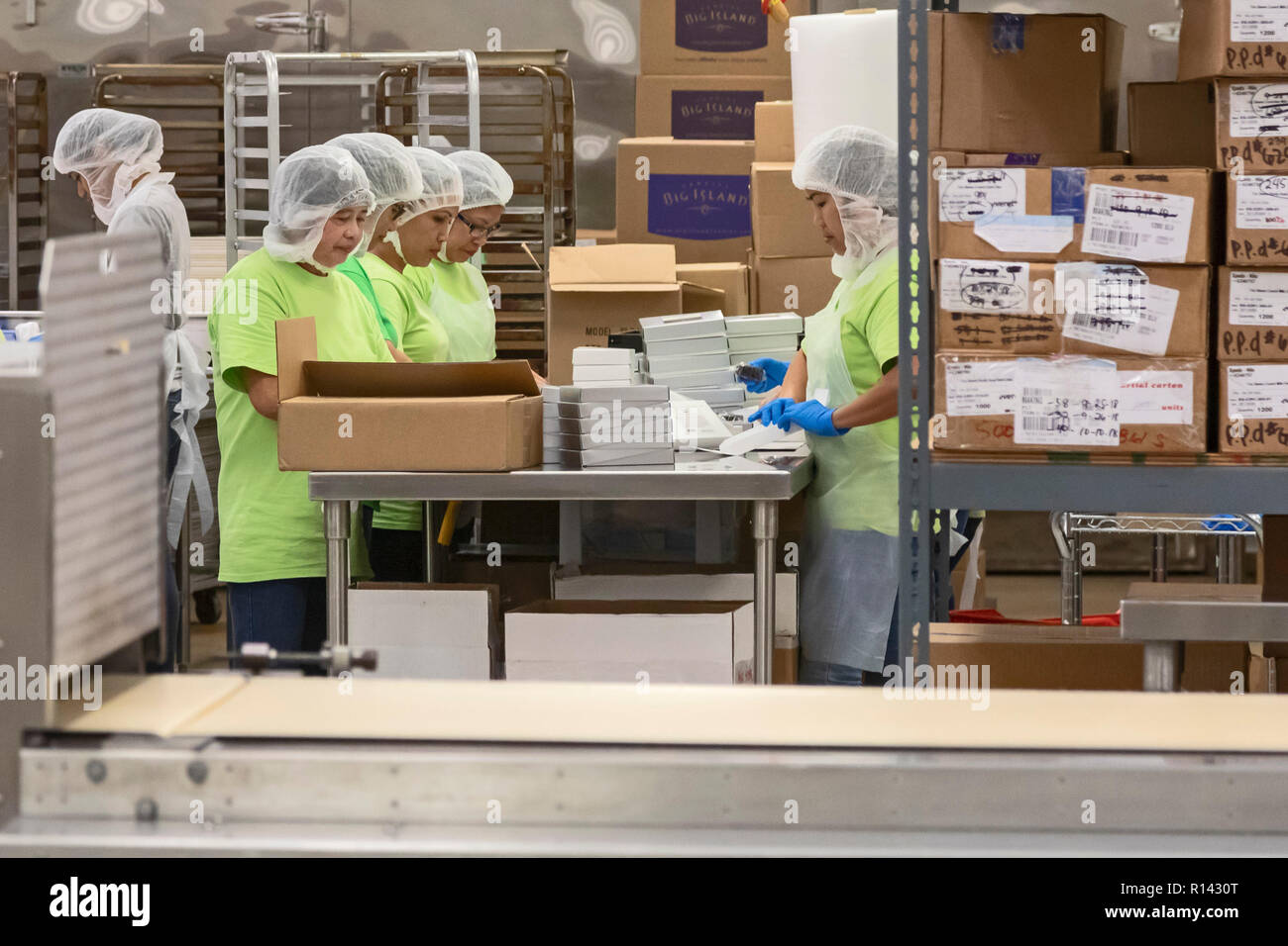 Hilo, Hawaii - Workers packaging candy at Big Island Candies. Stock Photo