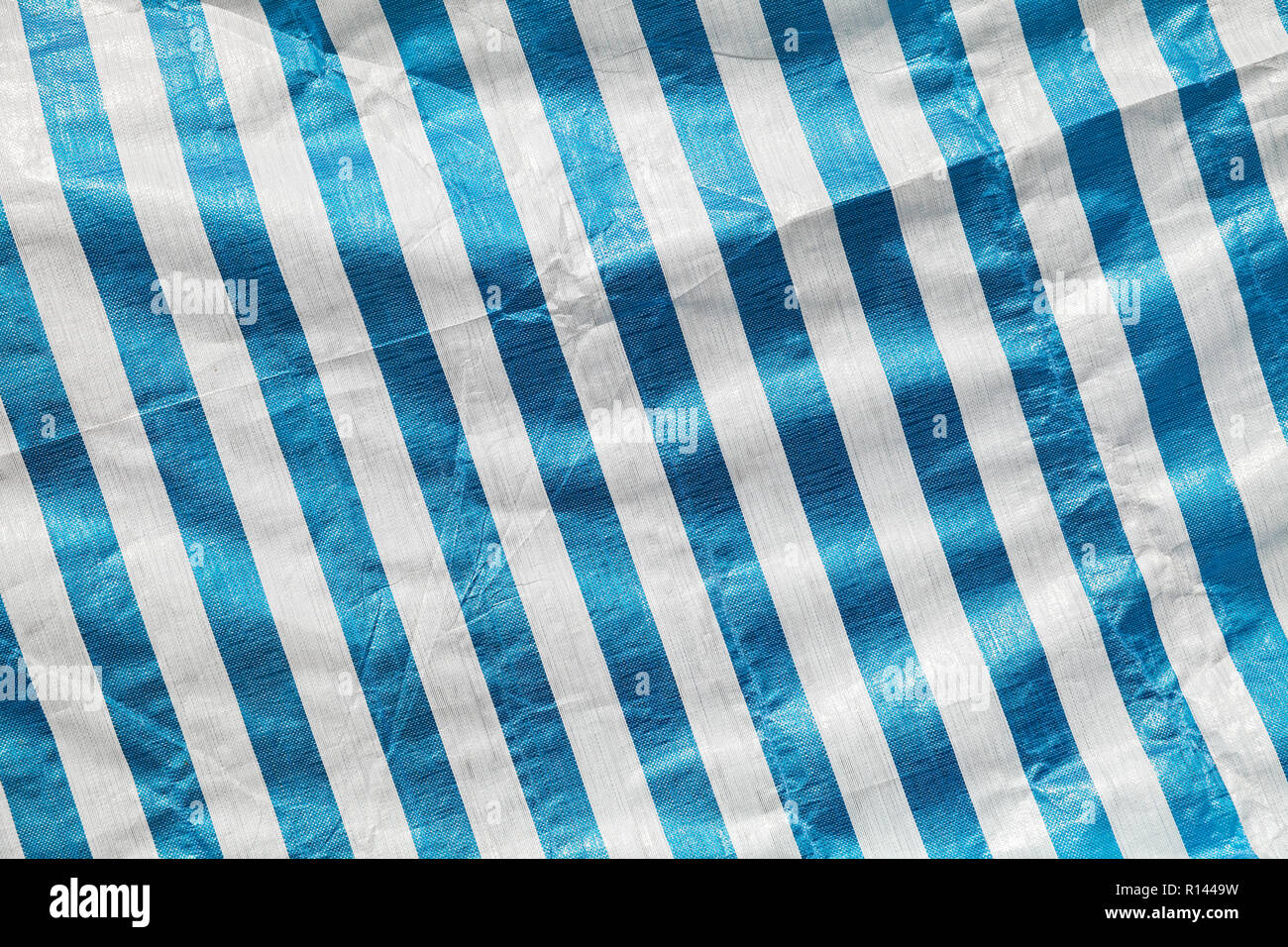 Creased plastic polyethylene film with striped pattern, background photo texture Stock Photo