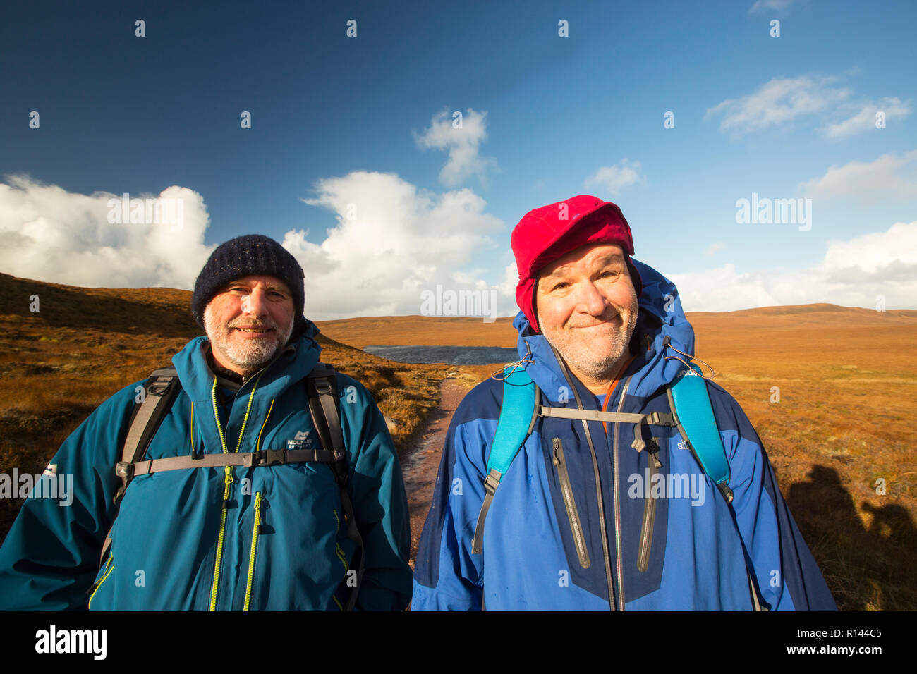 Hikers crossing a moorland path to Sandwood Bay, Sutherland, Scotland, UK. Stock Photo
