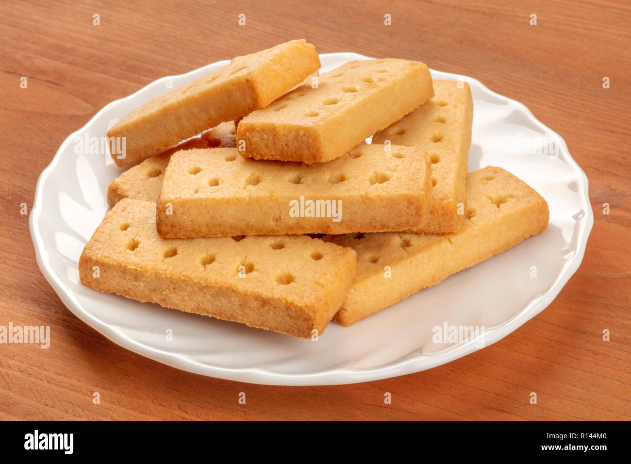 A closeup photo of Scottish shortbread butter cookies on a rustic wooden background Stock Photo