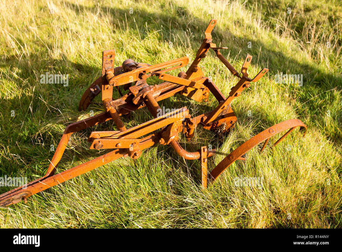 An old rusting farm implement at Balchrick, Sutherland, Scotland, UK. Stock Photo