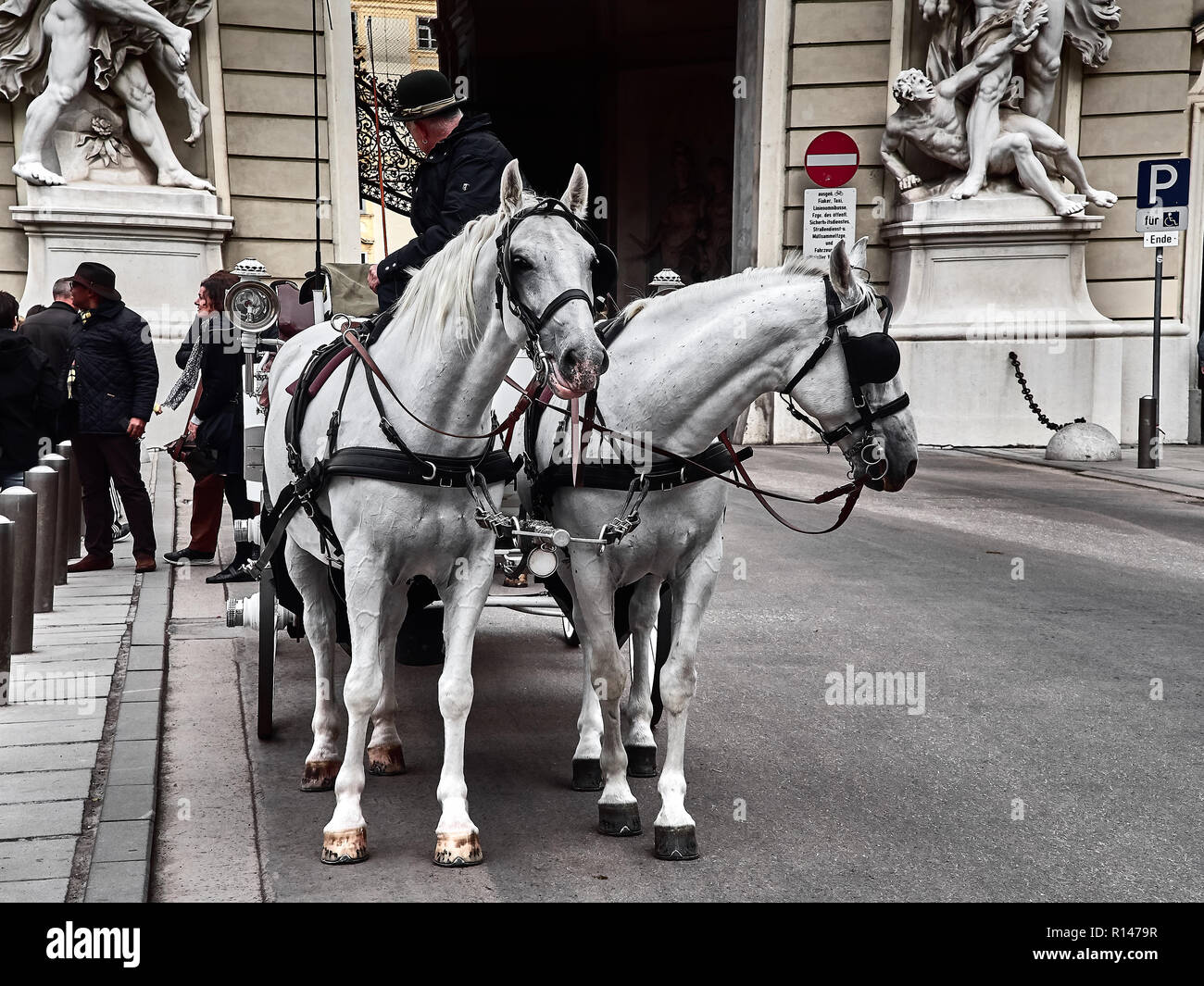 Vienna, Austria - November 1, 2018 - Shot of a classic horse-drawn carriage inside Hofburg palace street in Vienna Stock Photo