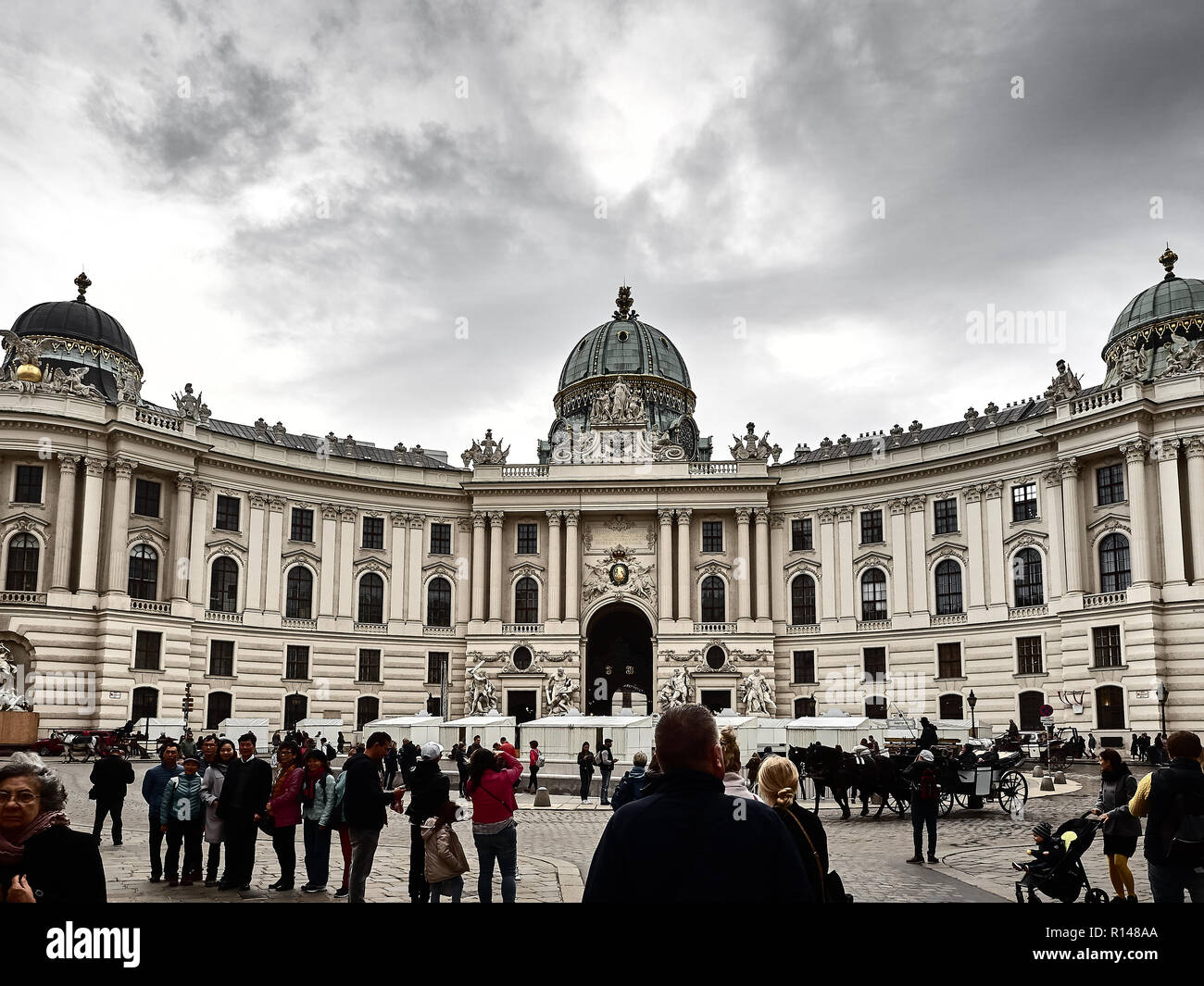 Vienna, Austria - November 1, 2018 - View of the Hofburg palace in Vienna city center. It's the historical royal palace. People are walking around to  Stock Photo