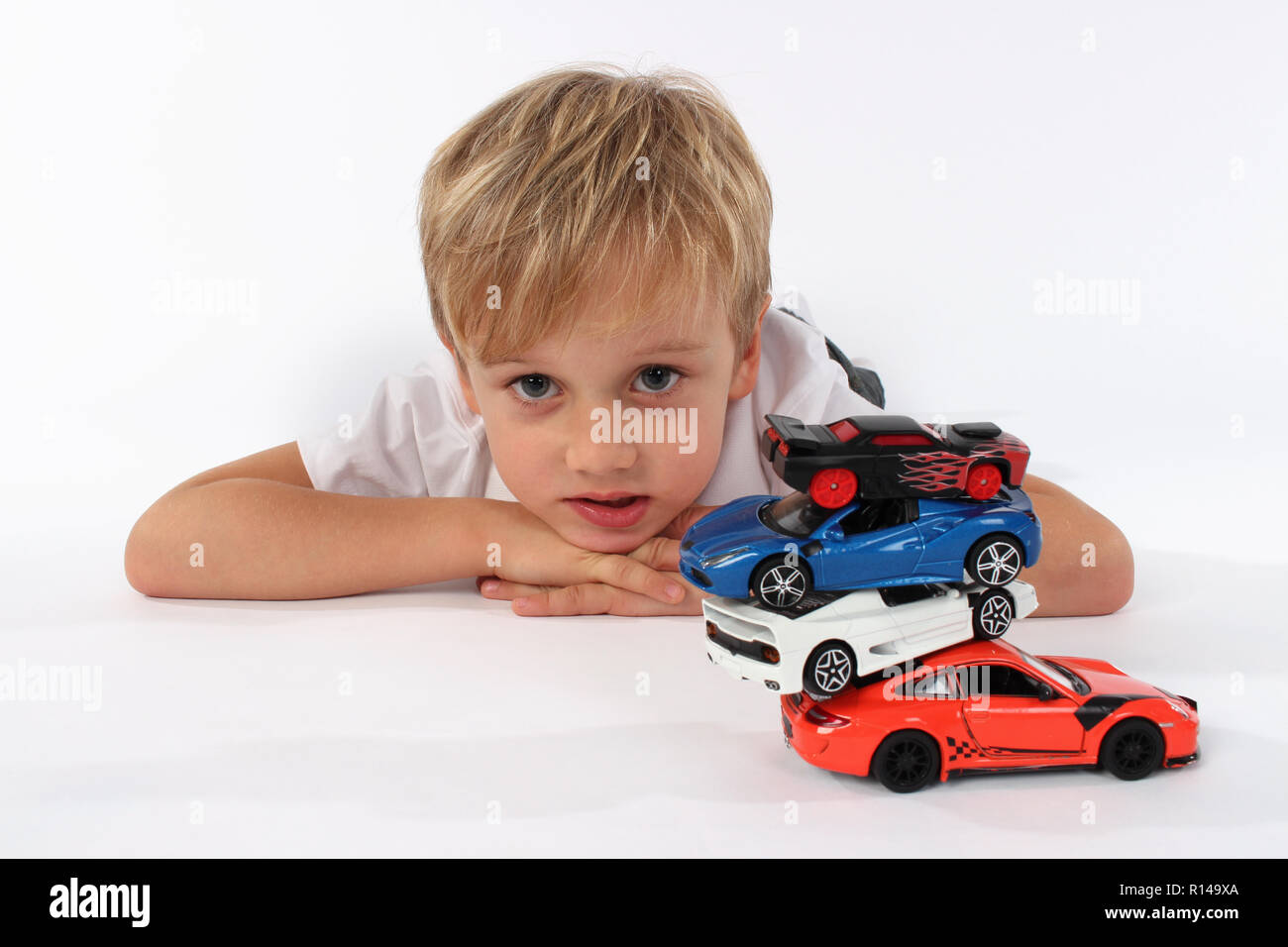 Child boy playing with toy cars in a studio Stock Photo - Alamy