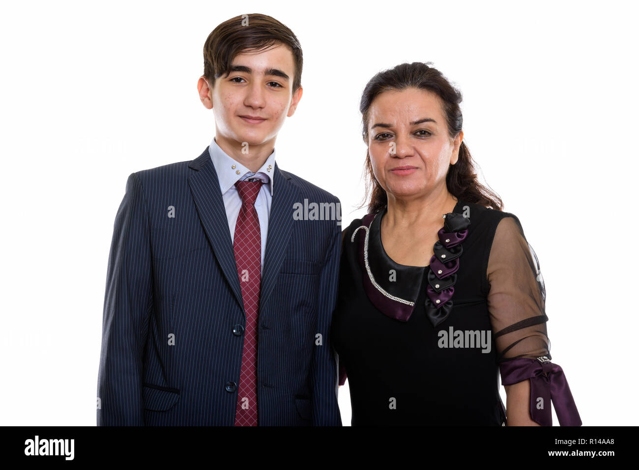 Studio shot of young Persian teenage businessman and mature Pers Stock Photo