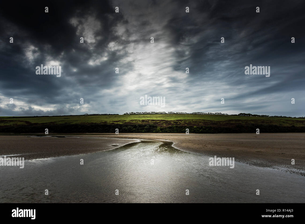 Late evening light over low tide in the Gannel Estuary in Newquay in Cornwall. Stock Photo