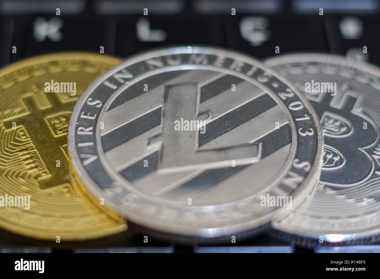 Cryptocurrency coins on computer keyboard Stock Photo