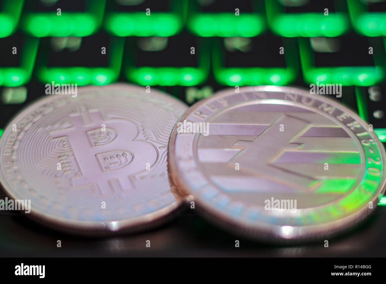 Cryptocurrency coins on illuminated computer keyboard Stock Photo