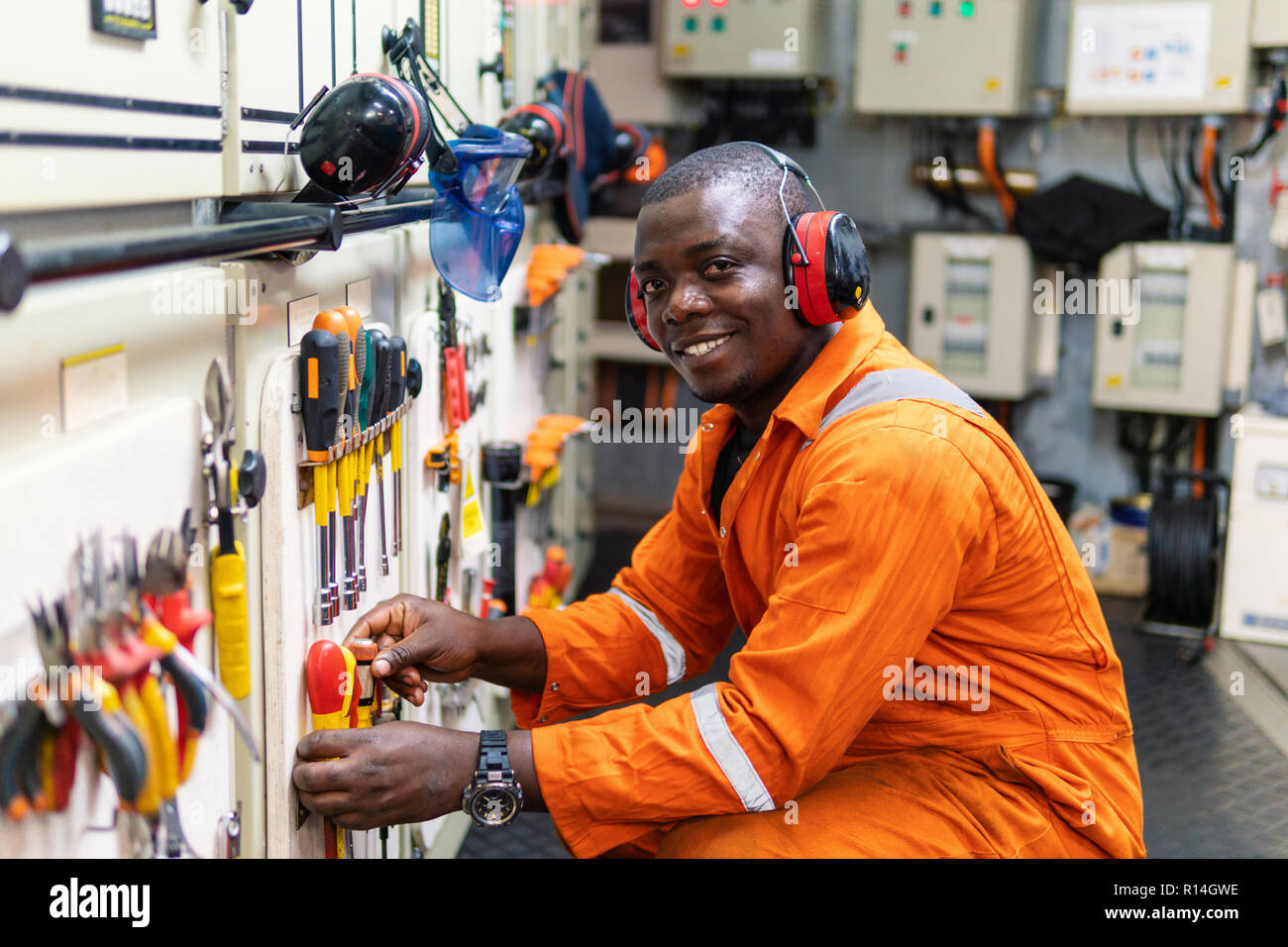 Marine engineer officer working in engine room Stock Photo Alamy