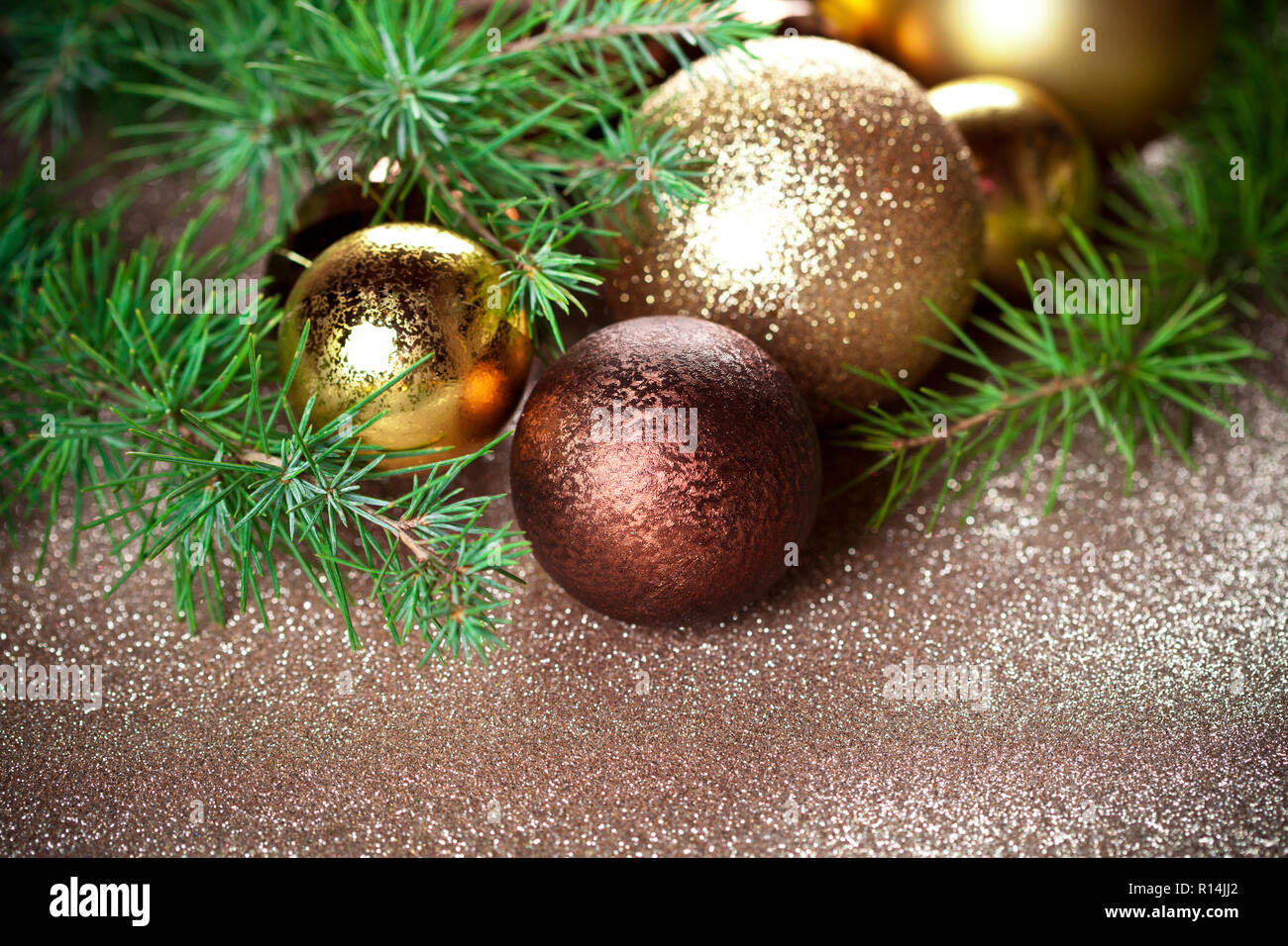 Christmas decorations and evergreen fir tree branch closeup on gold ...