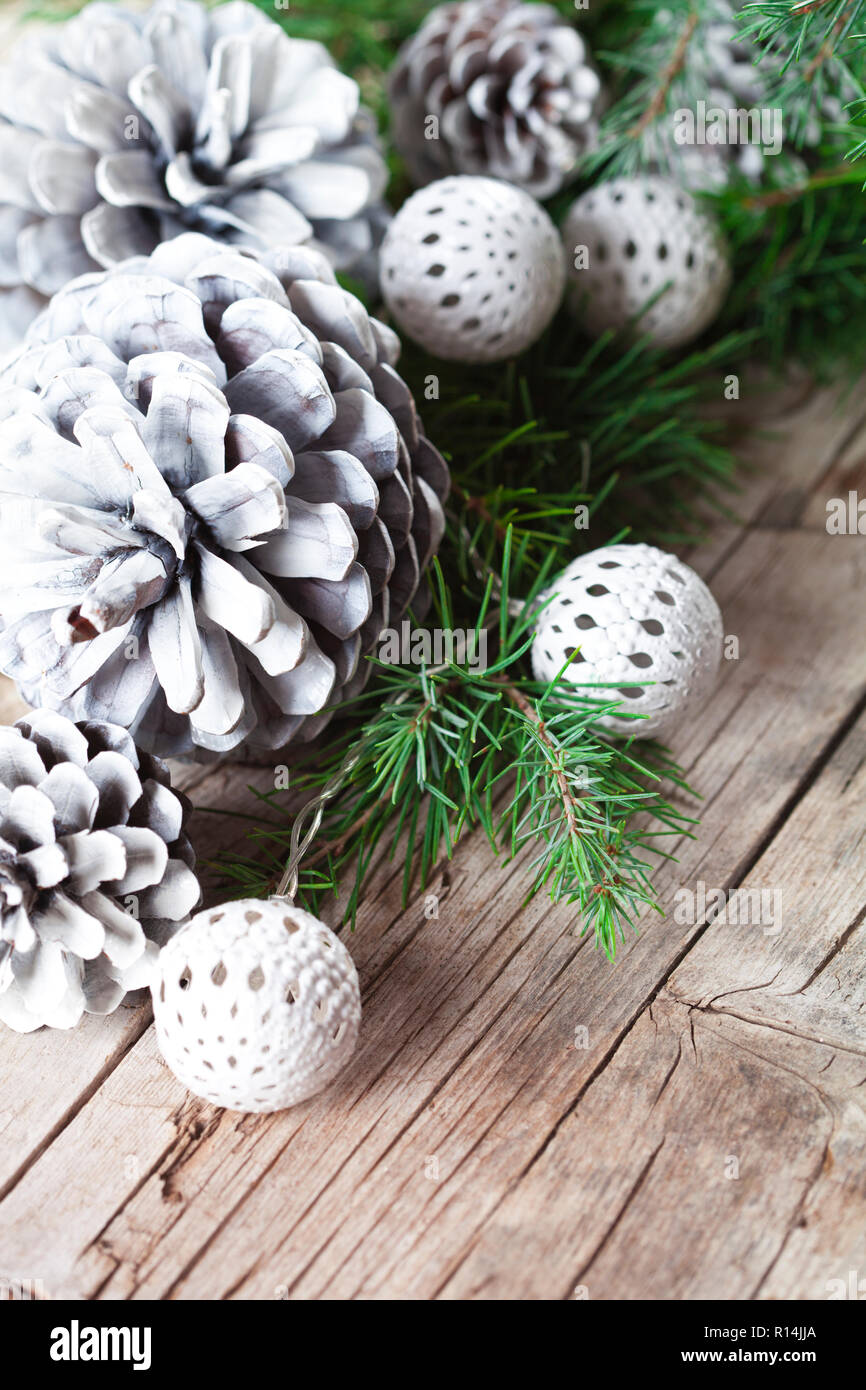 Christmas decorations. Evergreen fir tree branch, white pine cones and ...