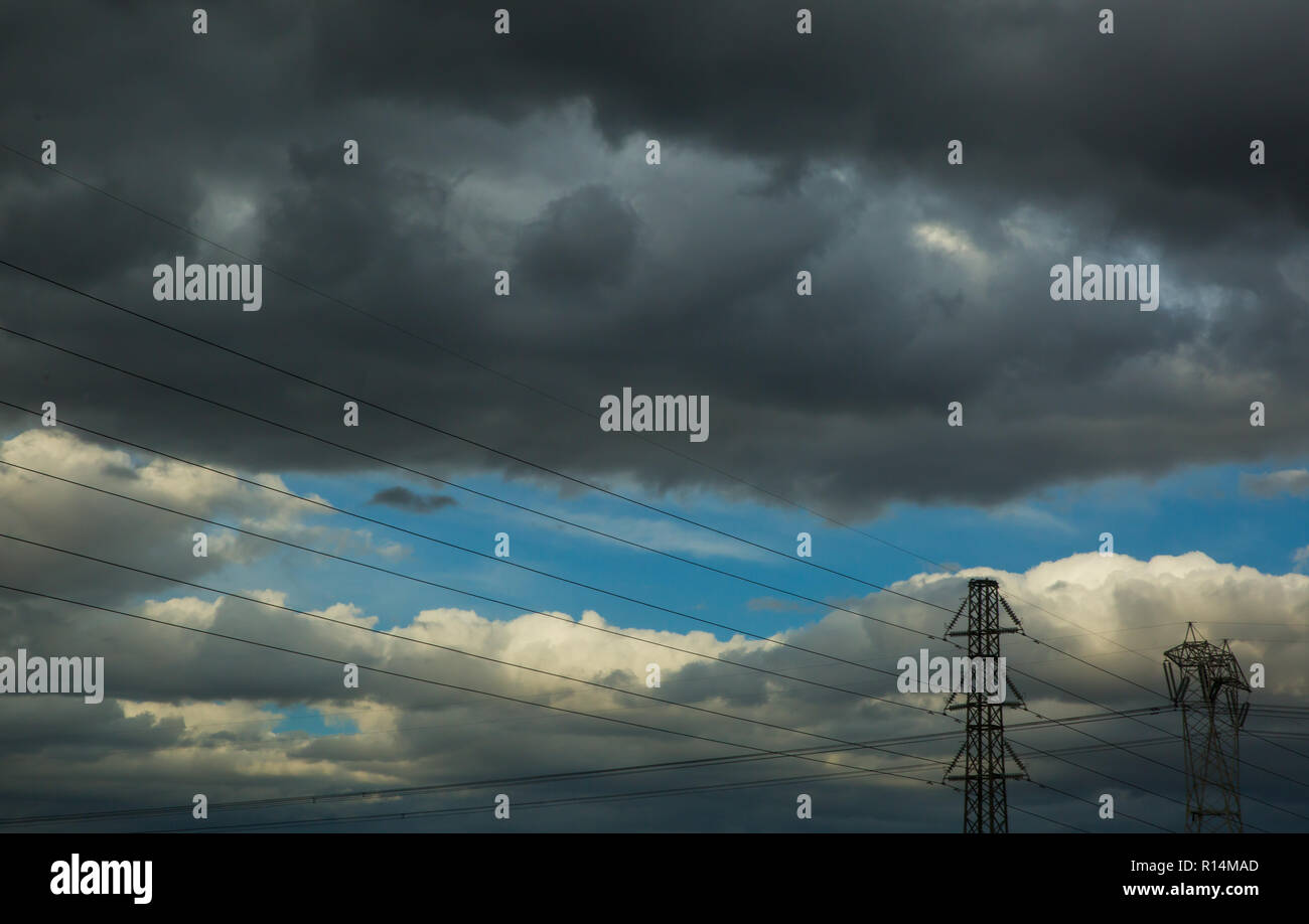 The electric pylon tower lines and dramatic sky Stock Photo