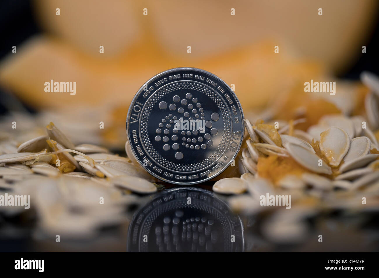 Iota cryptocurrency physical coin surrounded with pumpkin seeds Stock Photo  - Alamy