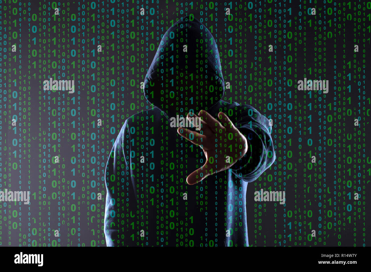 binary code on the background of the silhouette of a hacker in the hood ...