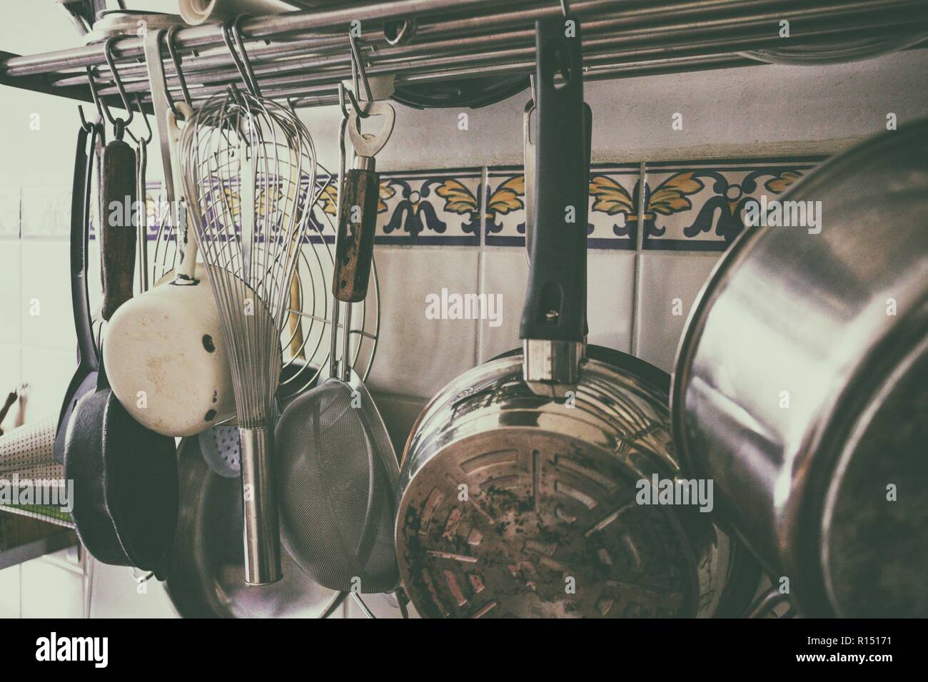 vintage processing kitchen utensils hanging in the kitchen Stock