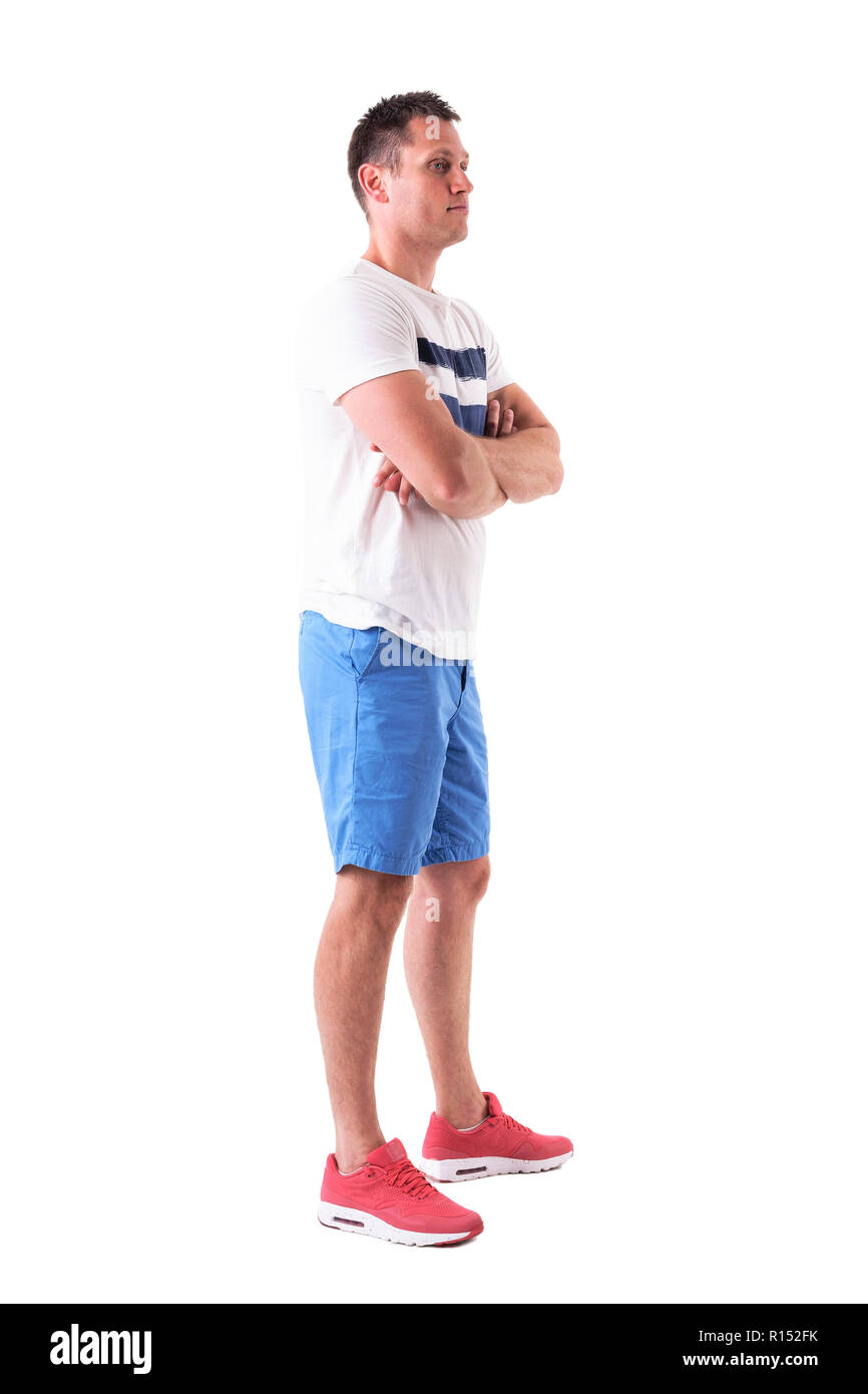 Side view of confident adult man with crossed arms looking away in ...