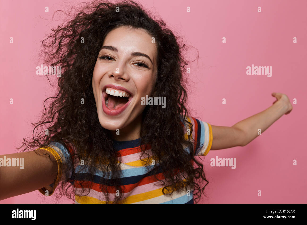 Image of an excited happy cute young woman posing isolated over pink ...