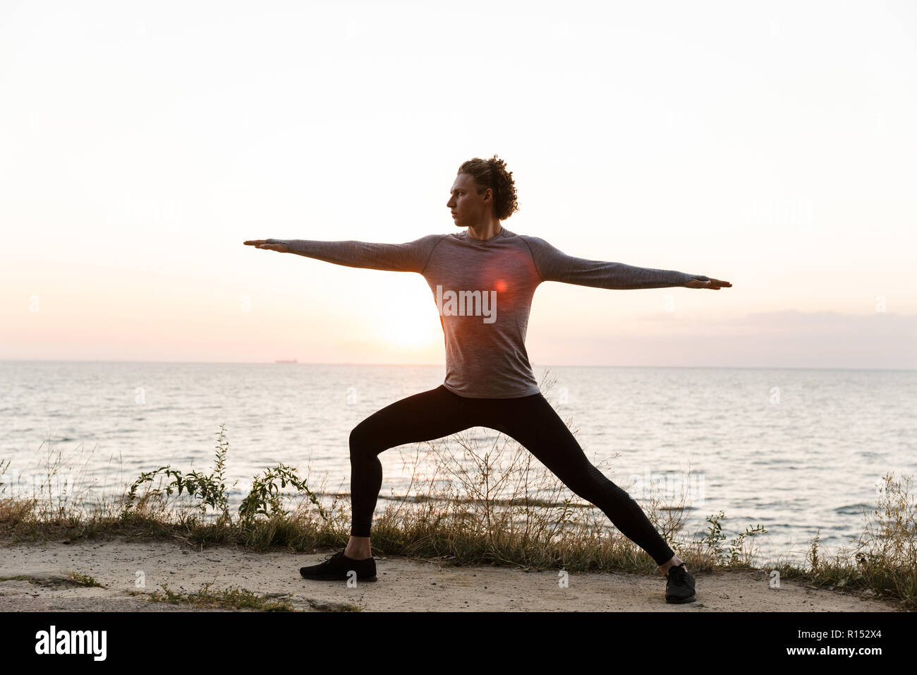 Young man stretching arm sunrise hi-res stock photography and images ...