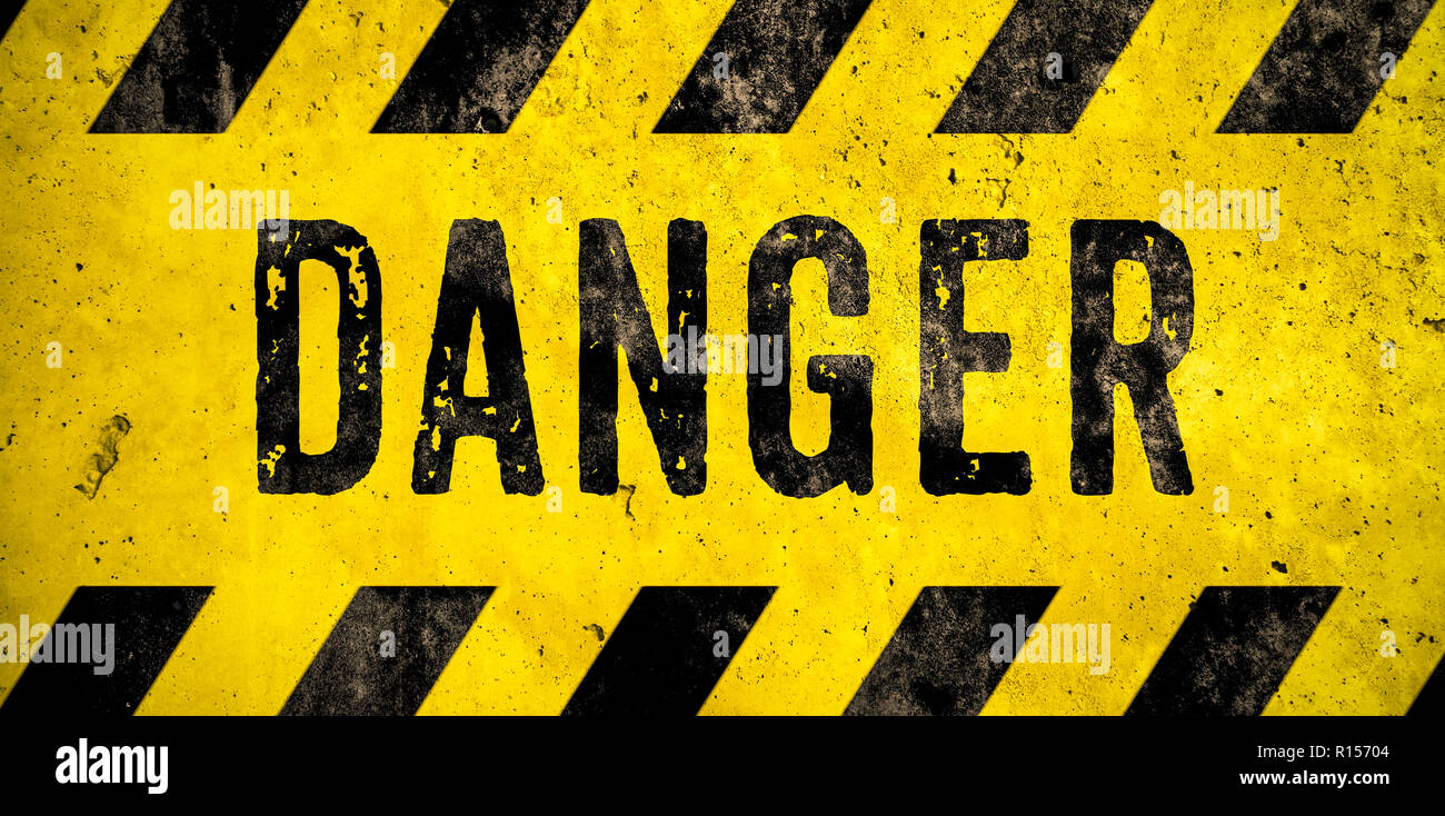 DANGER warning sign word text as stencil with yellow and black stripes