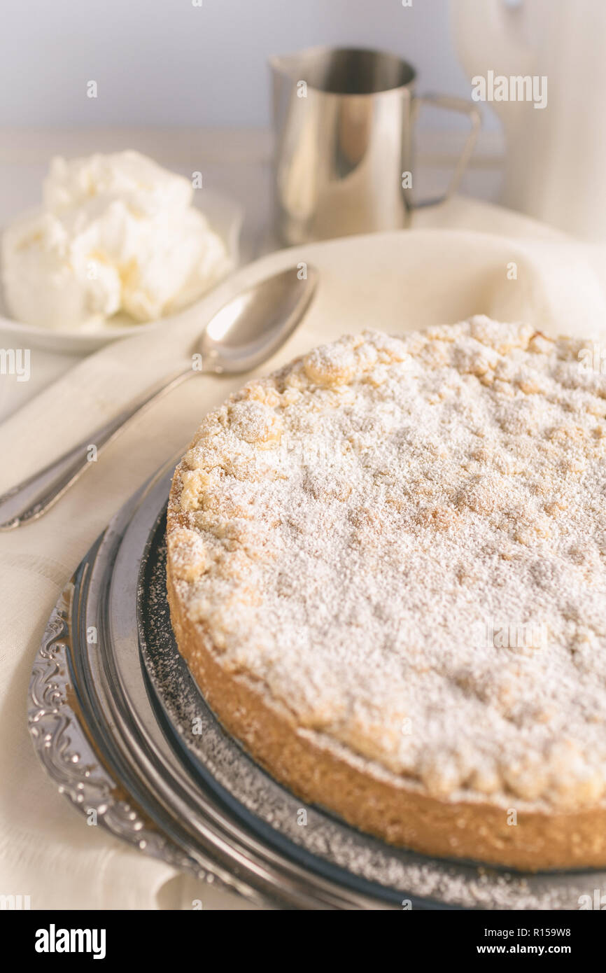 A homemade apple crumble cake on a cake plate Stock Photo