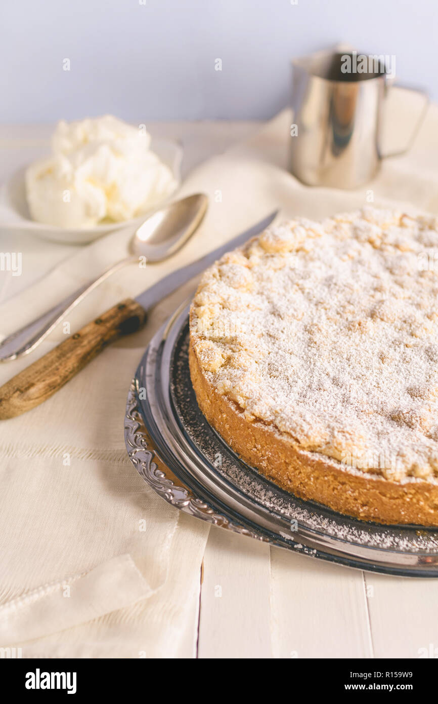 A homemade apple crumble cake on a cake plate Stock Photo