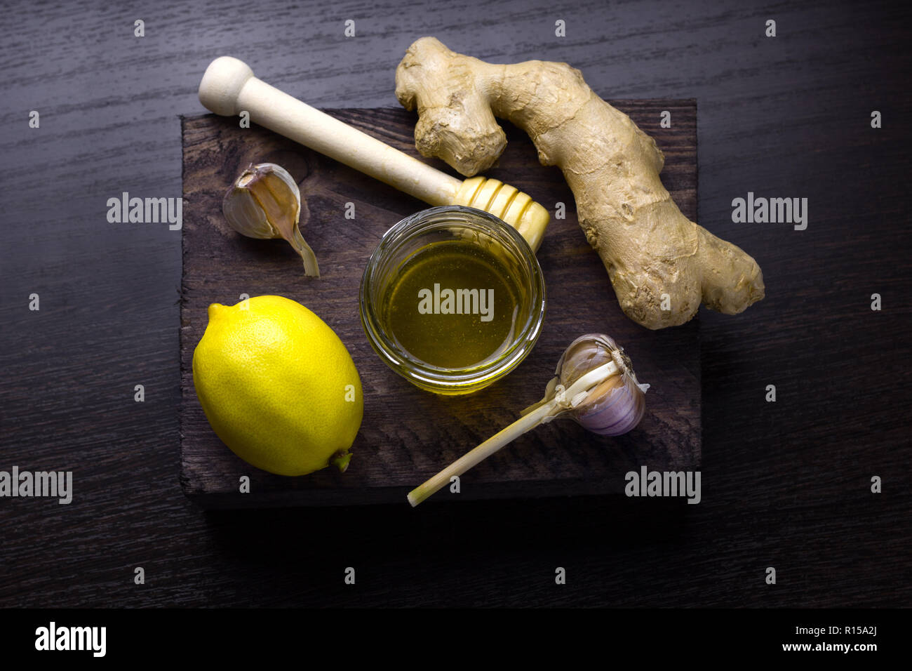top view ginger,lemon,honey   and garlic on a wooden board Stock Photo