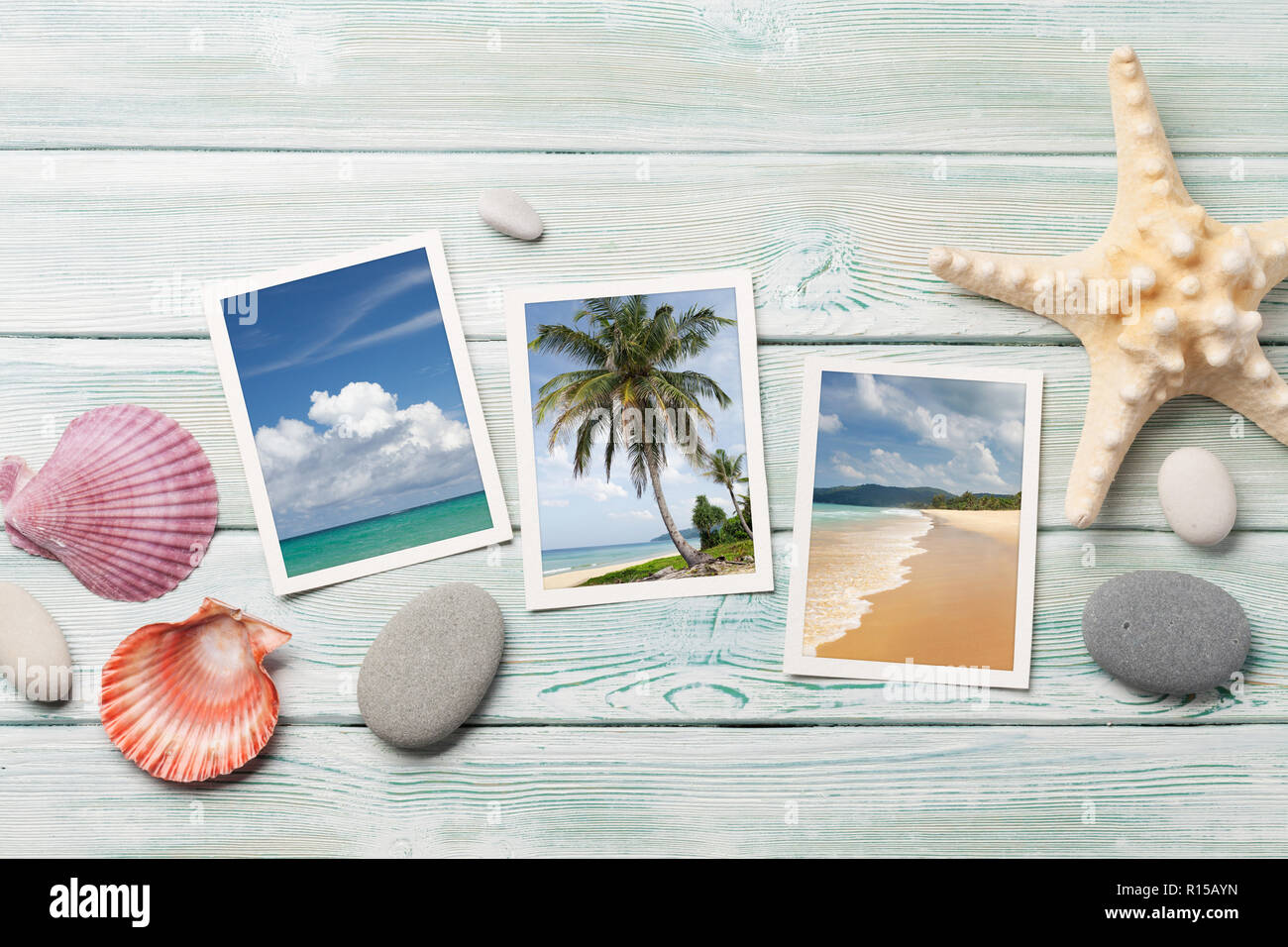 Travel vacation table concept with seashells and summer photos on wooden table. Top view. Flat lay. Photos taken by me. Stock Photo