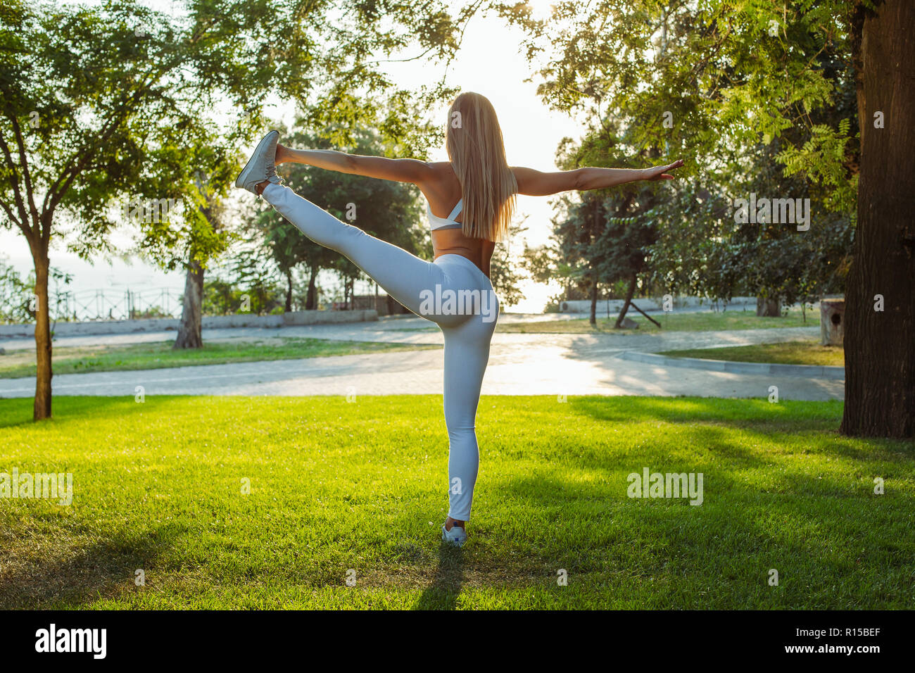 Beautiful Athletic Girl With Fit Body Doing Stretches Before Fitness Workout Stock Photo