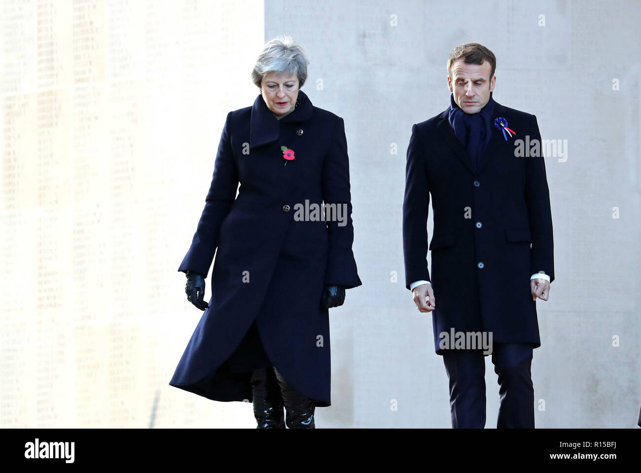Prime Minister Theresa May and French President Emmanuel Macron leave a wreath laying ceremony at the Thiepval Memorial in Authuille, France. Stock Photo