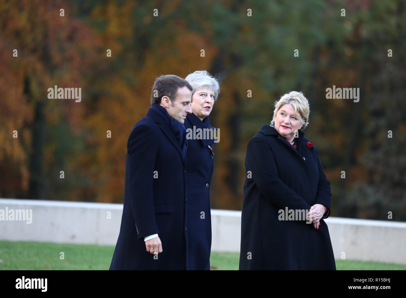 Prime Minister Theresa May, French President Emmanuel Macron and Victoria Wallace, director general of the Commonwealth War Graves Commission, leaving a wreath laying ceremony at the Thiepval Memorial in Authuille, France. Stock Photo