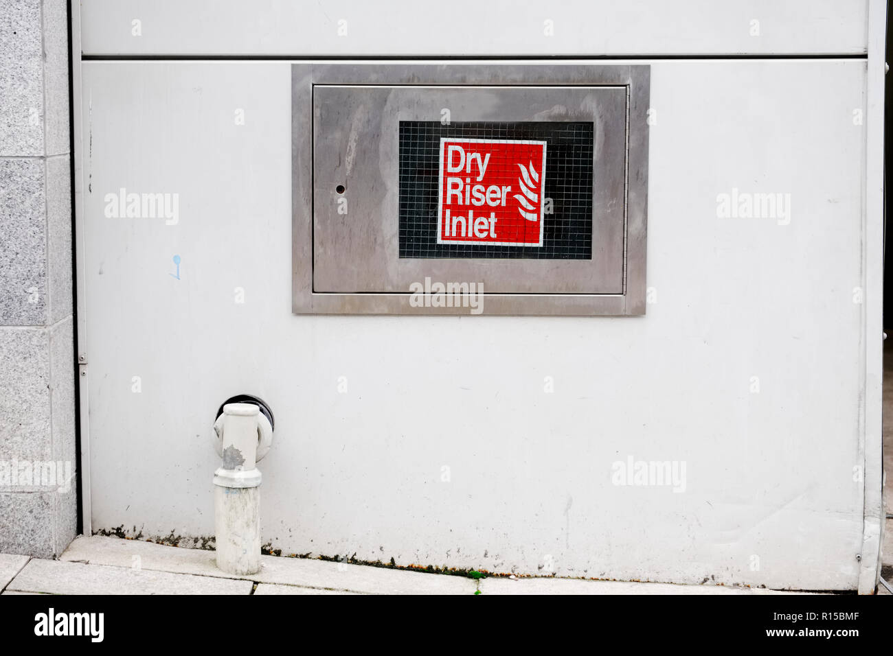 Dry riser inlet box stainless steel on wall office workplace sign Stock