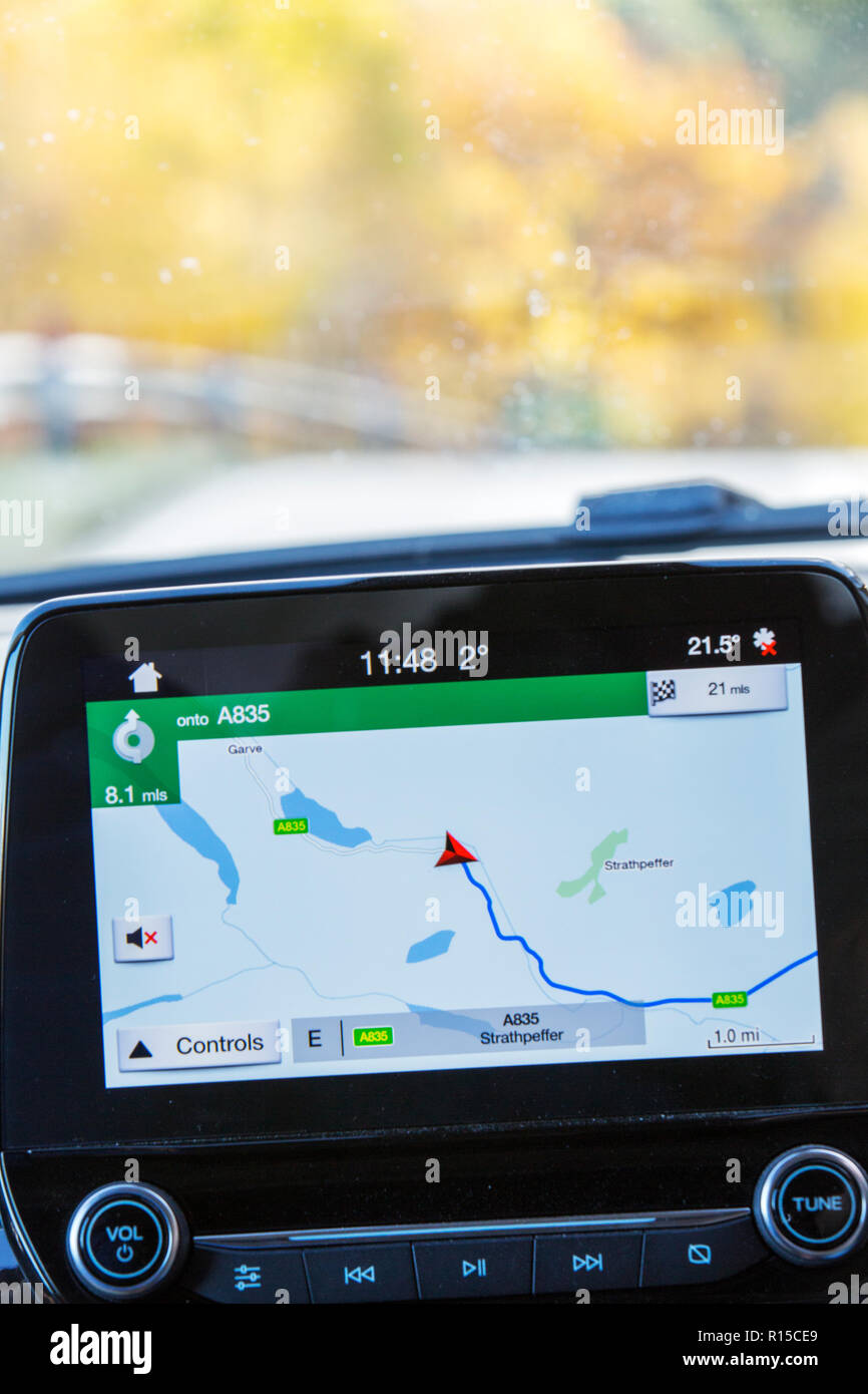 A sat nav in a car driving along the A835 near Garve, Scotland, UK