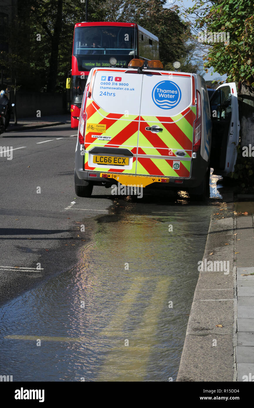 Thames Water Van attending burst water pipe flooding road Stock Photo